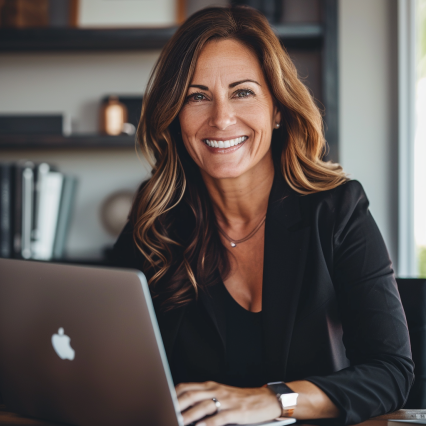 yannanyc1875_an_executive_woman_in_her_40s_on_a_laptop_sitting__adcf39d2-d5af-4c03-8186-0d827fb07930